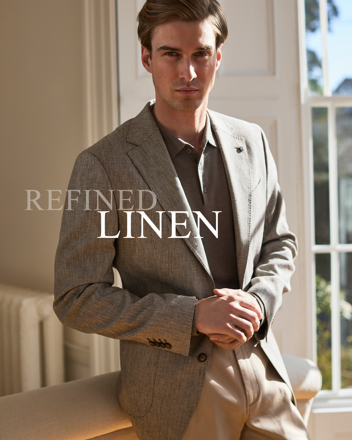 Man in grey blazer and brown shirt