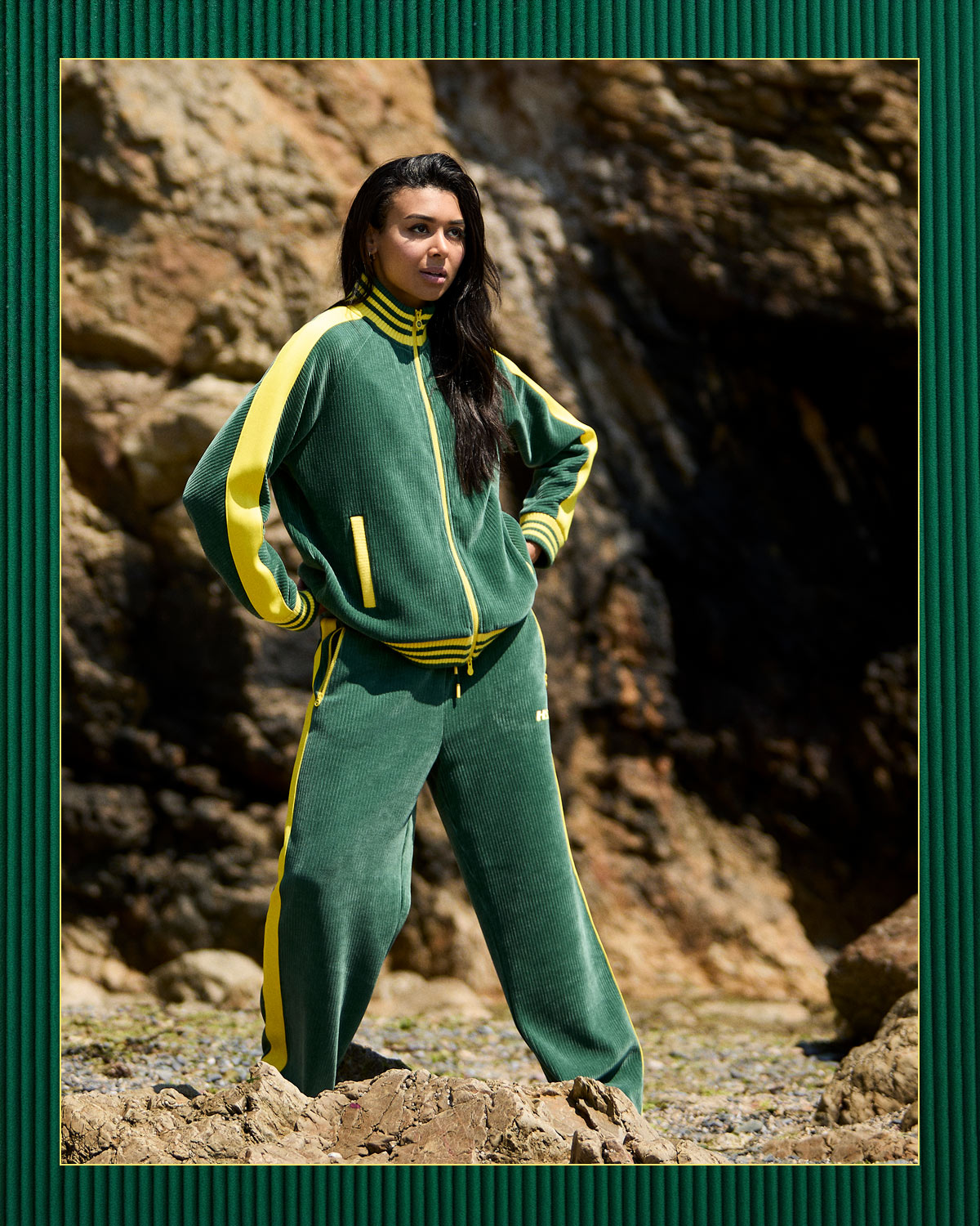 Dunnes Stores New from Helen Steele 3 Model in dark green corduroy tracksuit on rocky shore